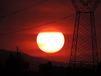 Low angle view of silhouette trees against orange sky
