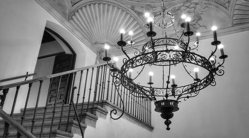 Low angle view of illuminated chandelier hanging in building