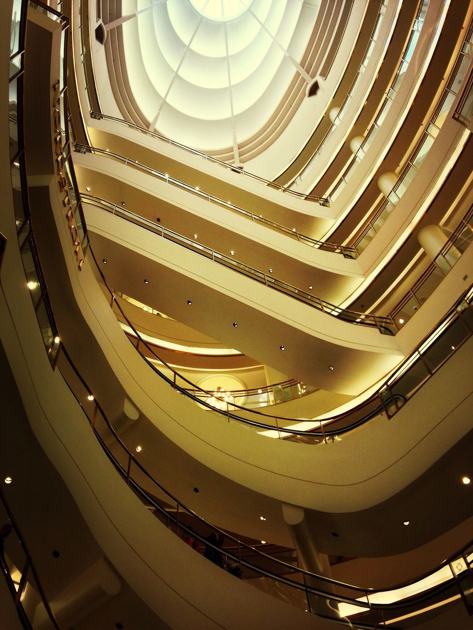 indoors, architecture, built structure, ceiling, staircase, steps and staircases, high angle view, pattern, steps, spiral, low angle view, architectural feature, railing, design, repetition, spiral staircase, modern, in a row, famous place, no people