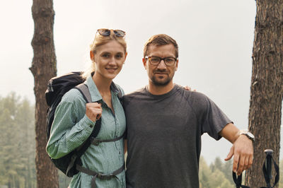 Portrait of couple standing against clear sky