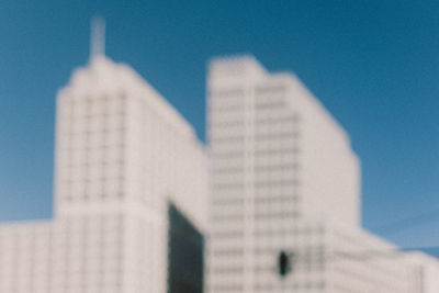 Low angle view of modern buildings against blue sky