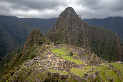Scenic view of mountain range against cloudy sky