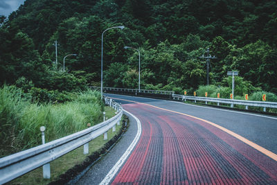 Road amidst trees in forest
