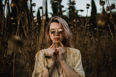 Portrait of young woman standing on land