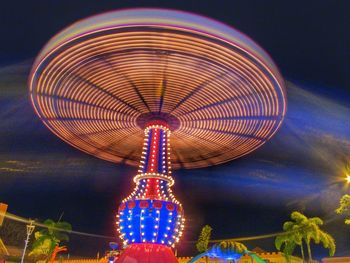 Low angle view of illuminated ferris wheel at night