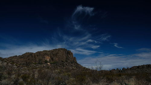 Low angle view of rocks on mountain against sky