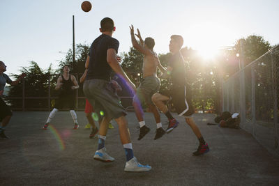 Basketball players playing in court