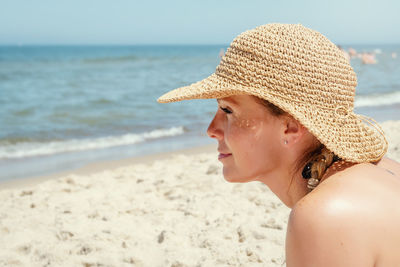 Close-up of woman in hat at beach