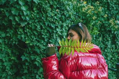 Woman standing by plants