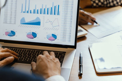 High angle view of man using laptop on table