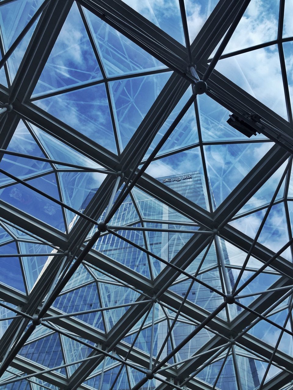 low angle view, built structure, architecture, full frame, pattern, sky, backgrounds, grid, metal, directly below, glass - material, day, architectural feature, metallic, no people, geometric shape, ceiling, design, indoors