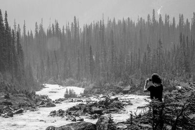 Rear view of person standing on snow covered land