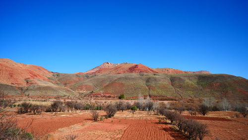 Scenic view of mountain against blue sky