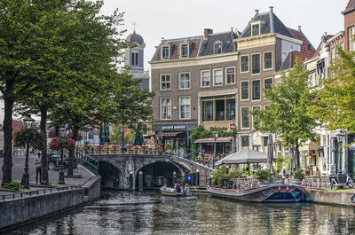 Bridge over canal amidst buildings in city