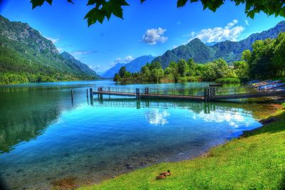 Scenic view of swimming pool by lake against sky