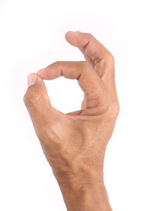 Close-up of human hand against white background