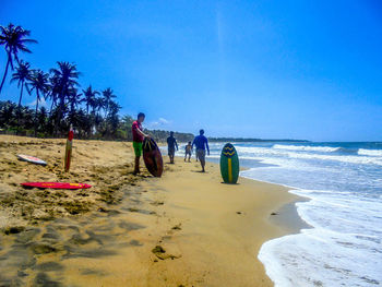 Scenic view of beach against blue sky