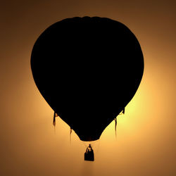 Silhouette hot air balloon against sky