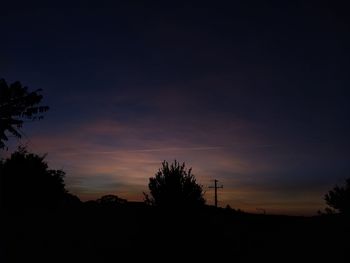 Low angle view of silhouette trees against sky at sunset