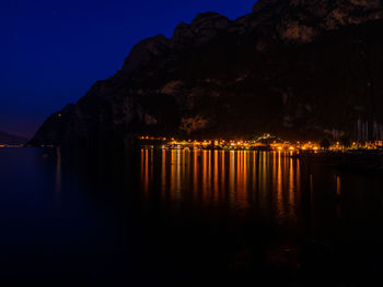 Scenic view of lake against sky at night