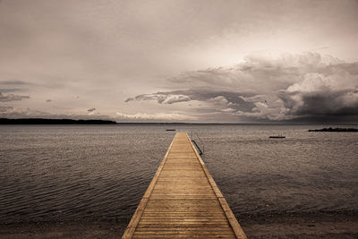 Pier over sea against sky