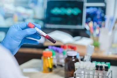 Cropped hand of scientist holding test tube at laboratory