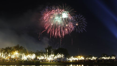 Low angle view of firework display at night