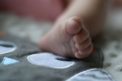 Low section of baby on bed