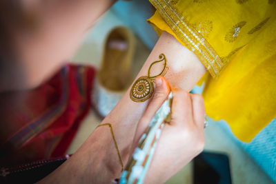 Hand of an indian bride decorated with henna or mehndi