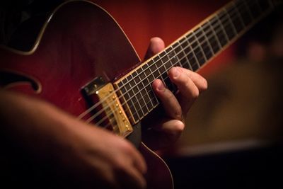 Cropped hands of man playing guitar