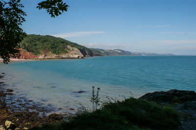 Scenic view of sea against blue sky