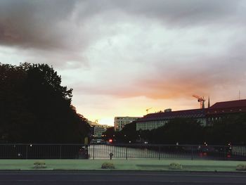 Silhouette of buildings against cloudy sky