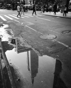 Reflection of buildings in puddle