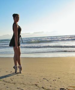Ballerina standing on beach