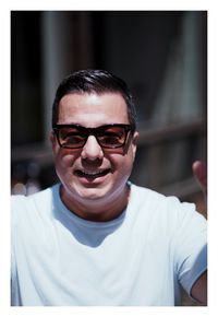 Portrait of young man wearing sunglasses outdoors