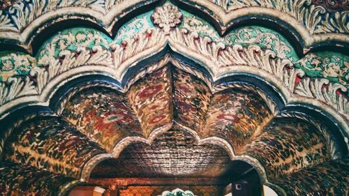 Low angle view of ornate ceiling in temple