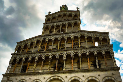 Low angle view of old building against cloudy sky