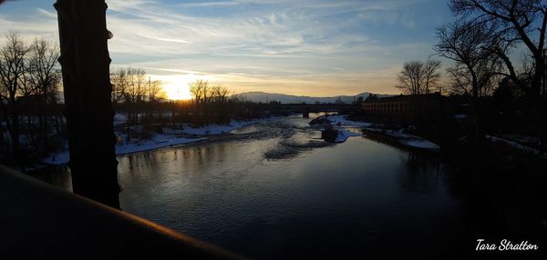 Scenic view of frozen lake against sky during sunset