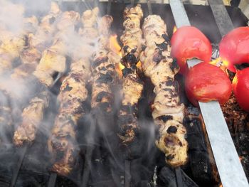 High angle view of meat on barbecue grill