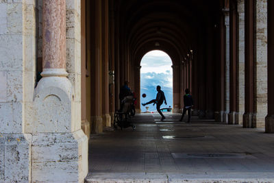 Rear view of people walking in building