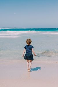 Rear view of boy on beach