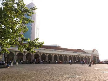 Group of people in front of building against sky