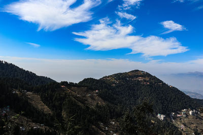 Scenic view of mountains against blue sky