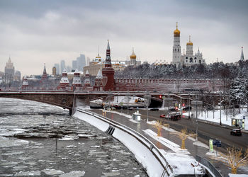 View of bridge and church in city against sky