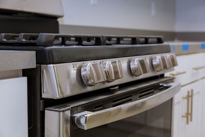Close-up of knobs on stove in kitchen