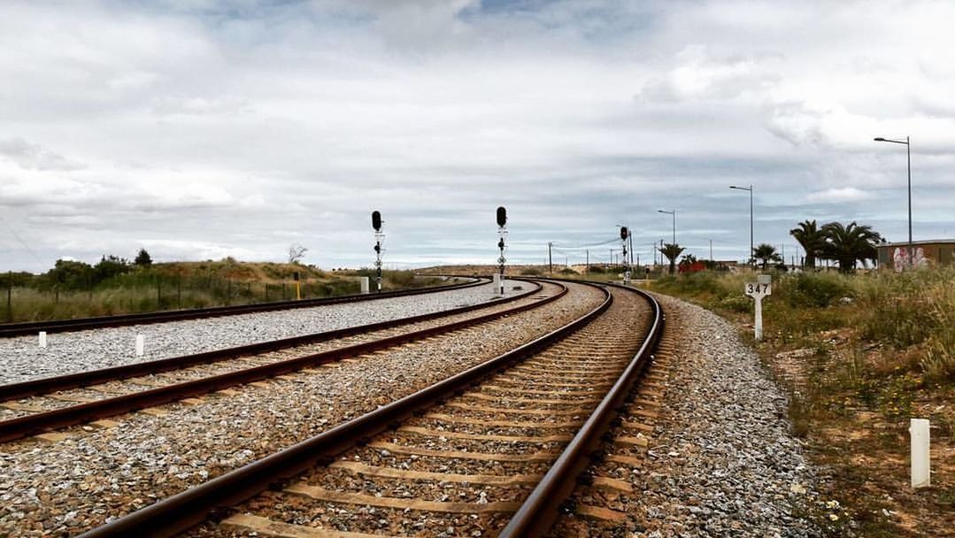 VIEW OF RAILROAD TRACK AGAINST SKY