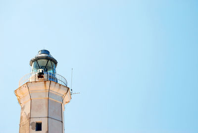 Low angle view of lighthouse against clear blue sky