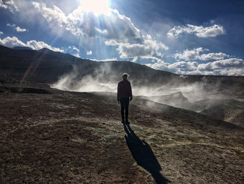 Man standing on mountain against sky