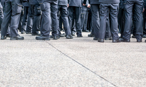 Low section of police force standing on road