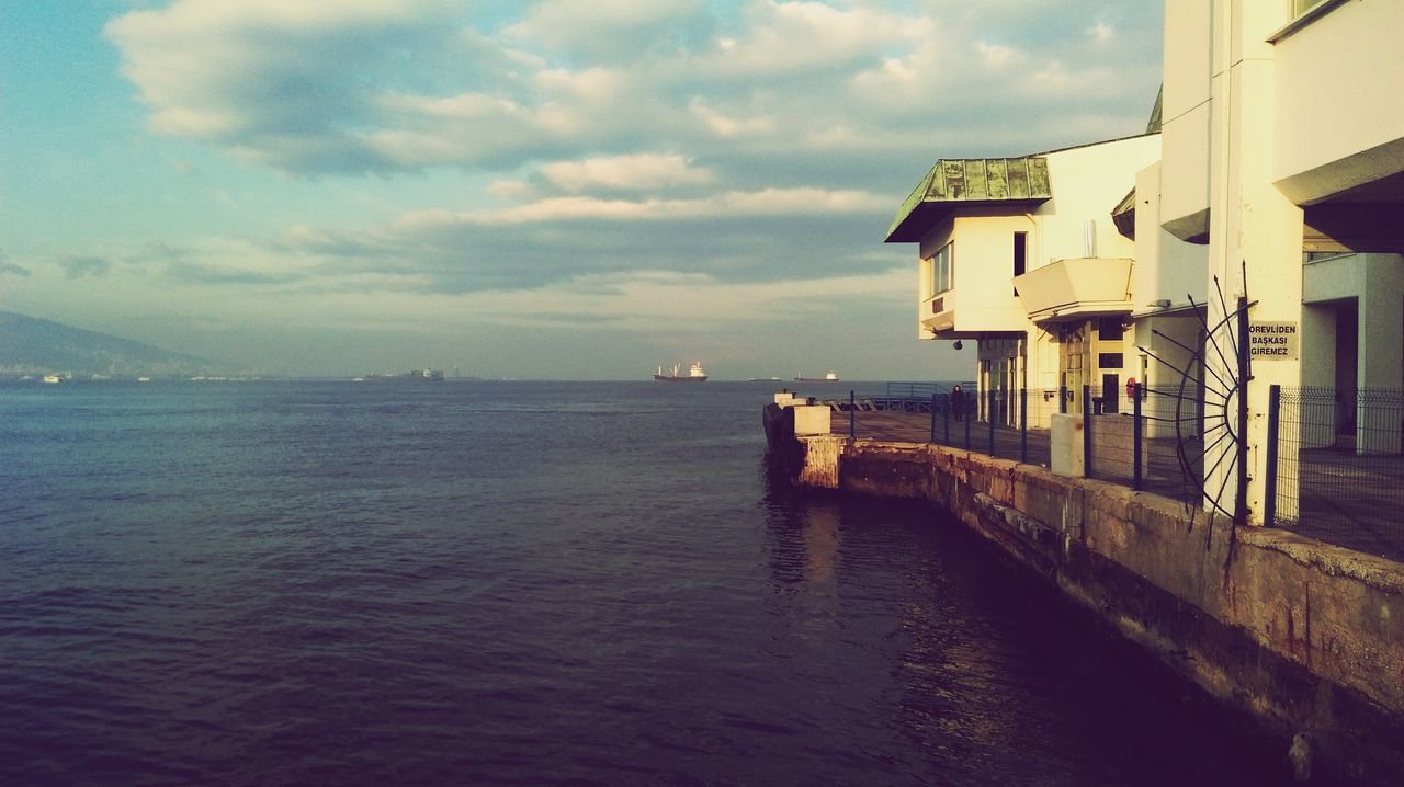 water, sea, sky, built structure, architecture, building exterior, waterfront, horizon over water, cloud - sky, sunset, scenics, cloud, nature, tranquility, rippled, nautical vessel, beauty in nature, tranquil scene, pier, transportation